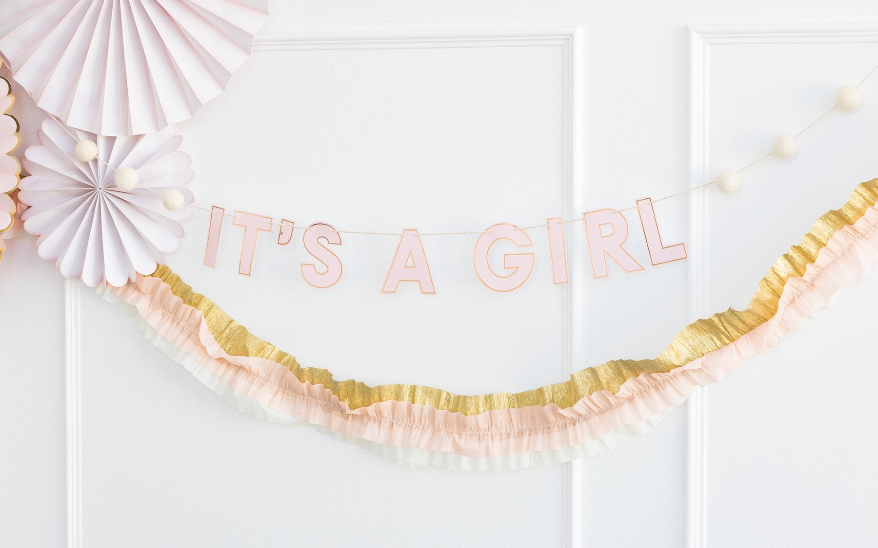 My Mind's Eye Baby Girl in Pink Banner on White Wall  with Pink Paper Fan and Pink and Gold Paper Crepe Banner