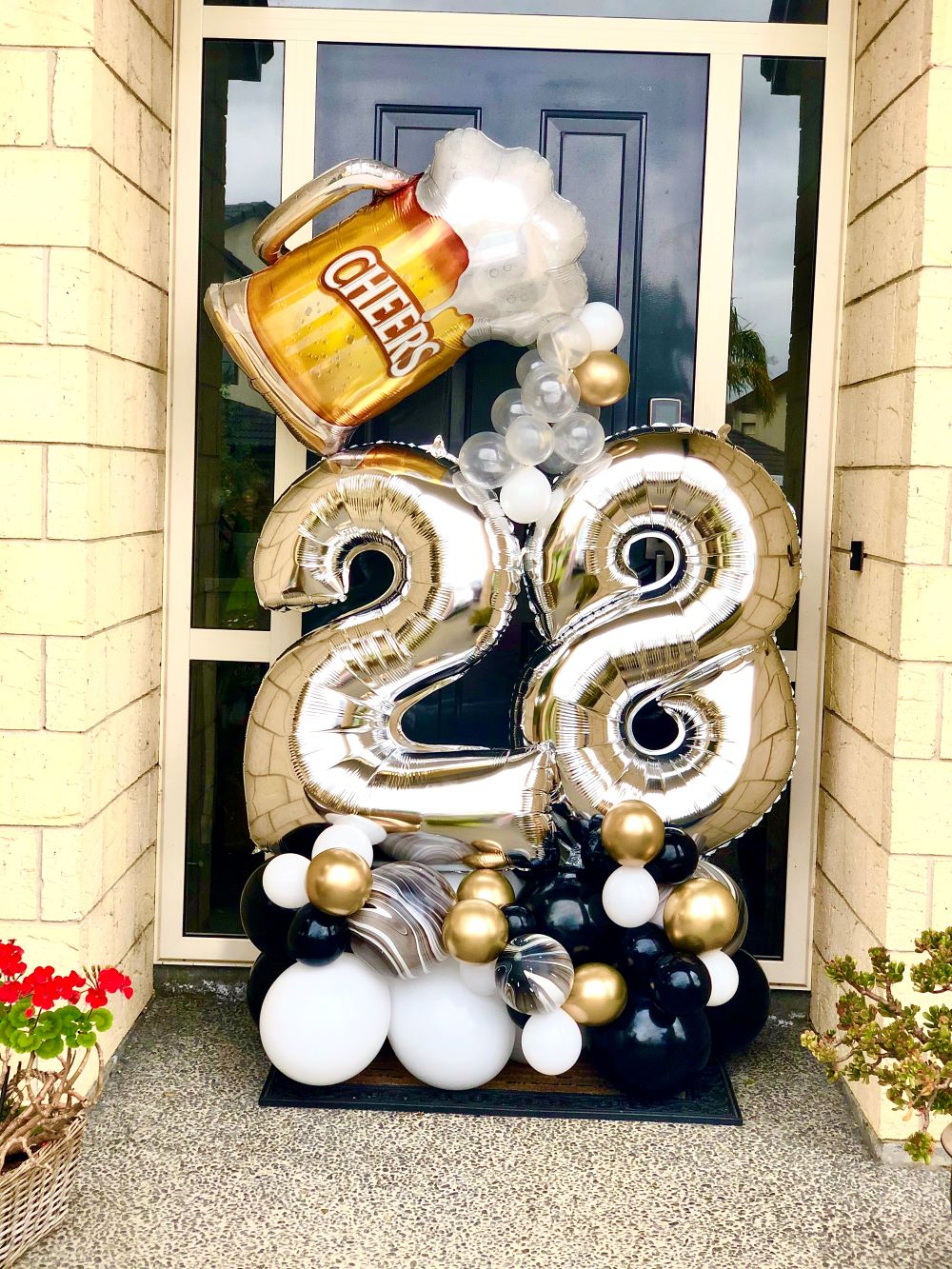 Black Beer Balloon Bouquet with Silver Number Balloons and Beer Mug Balloon at front door 