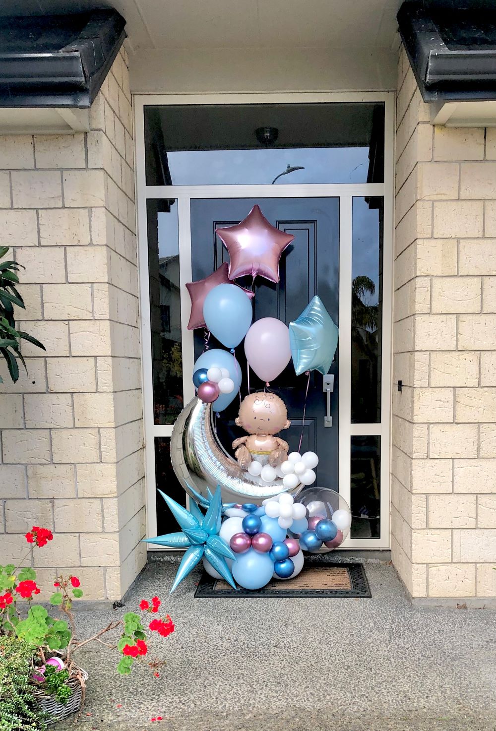 My Party Box Boy or Girl Gender Reveal Balloon Bouquet in front of door 