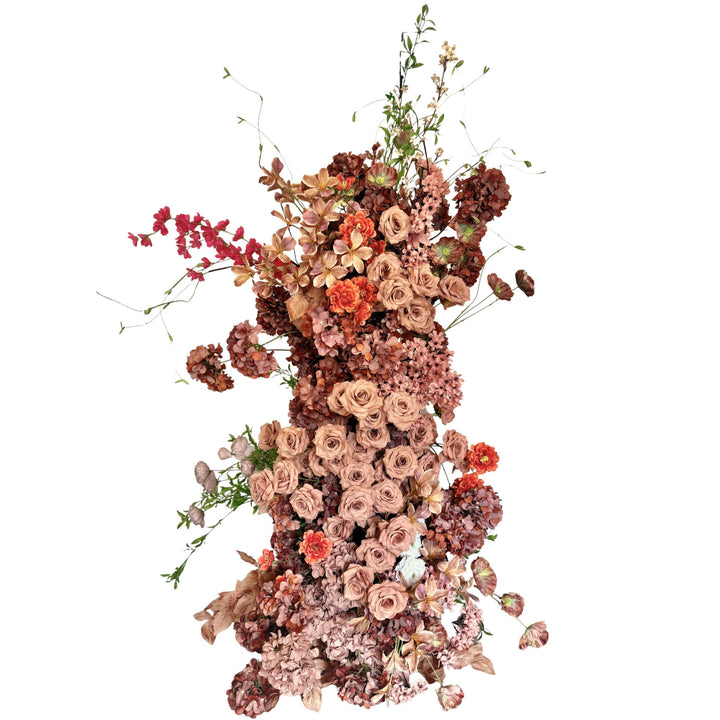 Floral arrangement with various dried flowers in earthy tones.