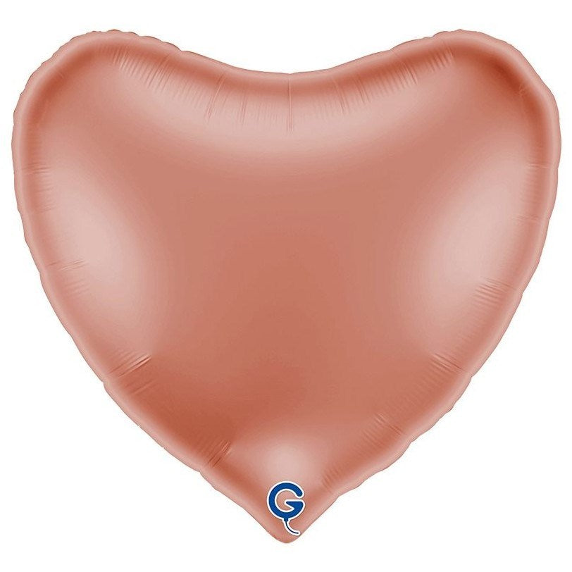 A heart-shaped foil balloon in a metallic rose gold color, shown against a plain white background with a small blue and white logo at the bottom.