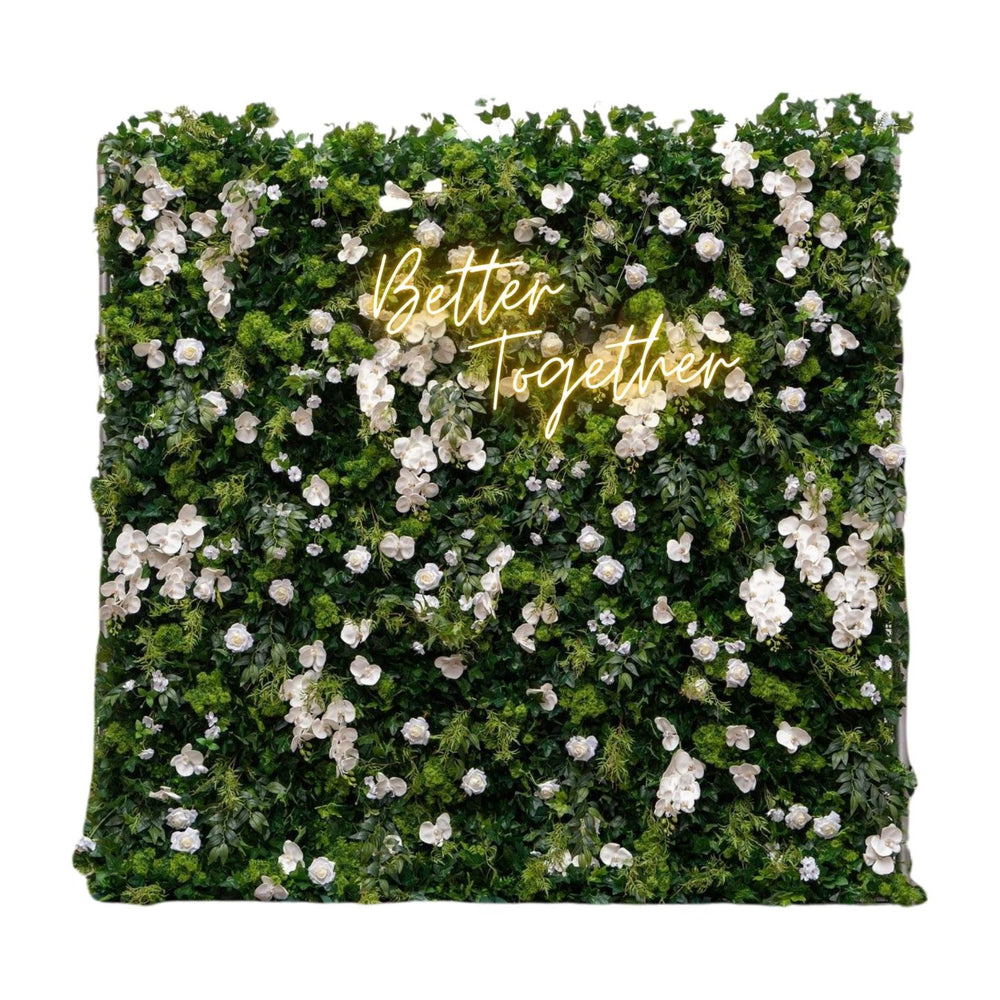 Floral wall with 'Better Together' text in gold on a white background