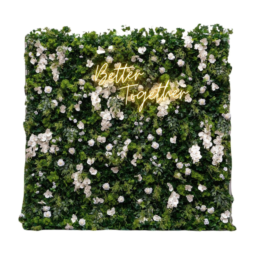 Floral wall with 'Better Together' text in gold on a white background
