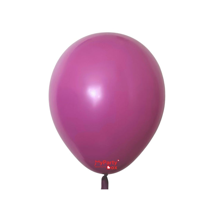 Pink helium balloon with a shiny surface on a white background.