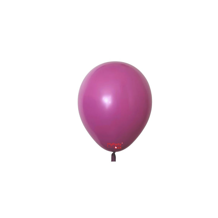 A single magenta purple latex party balloon isolated on a white background.