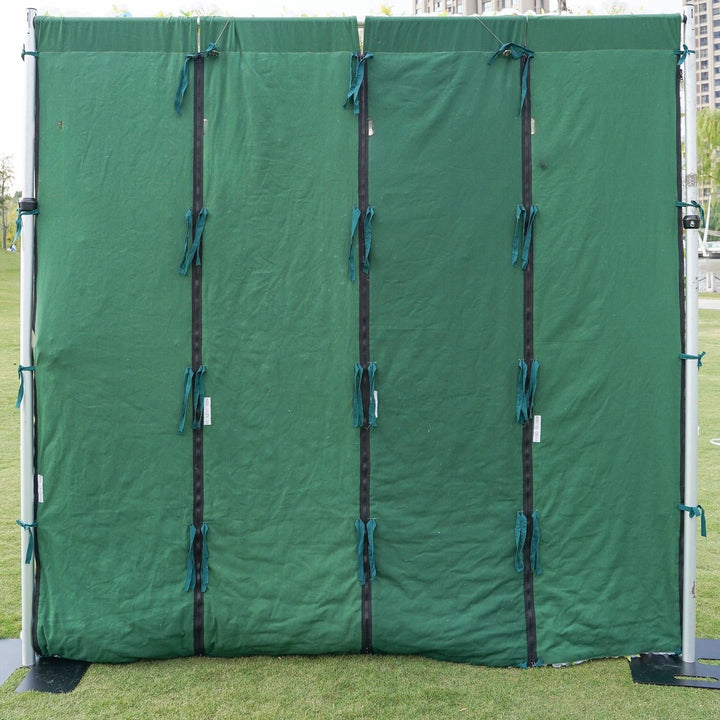 Green privacy screen with straps on a grassy area