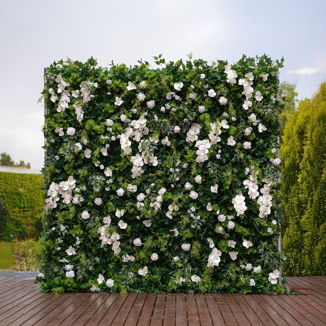Green and white floral wall on a wooden deck with trees in the background