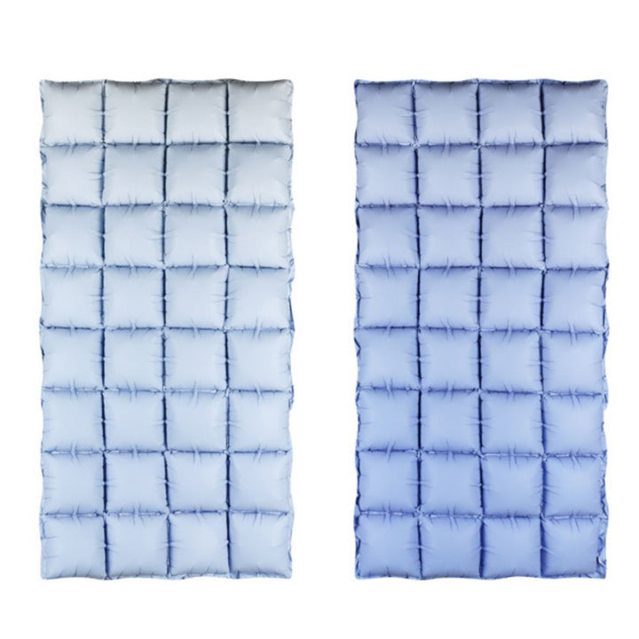 Two blue quilted mats with a grid pattern on a white background