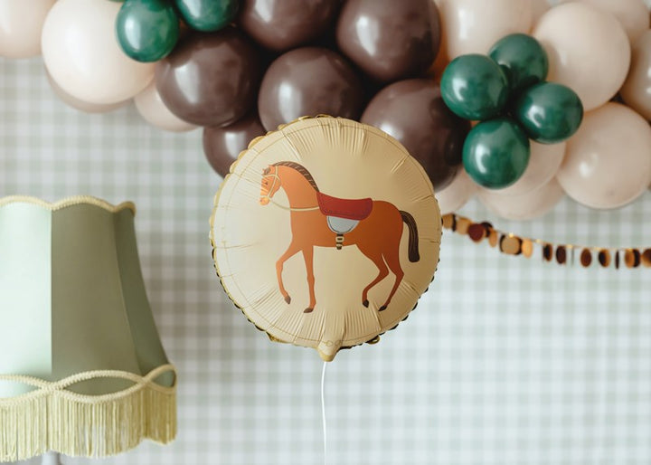 Horse-themed balloon with a background of colorful balloons and decorative ribbons.