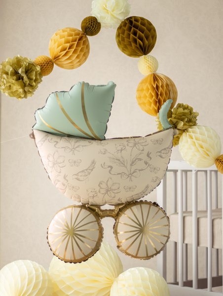 Decorative baby shower balloon hanging paper flowers and a pillow.