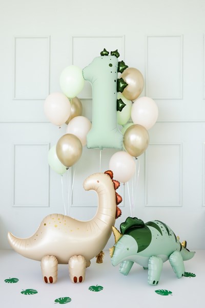 Decorative balloons shaped like dinosaurs and a number '2' against a white wall.