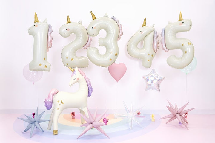 Unicorn-shaped number balloons on a light pink background