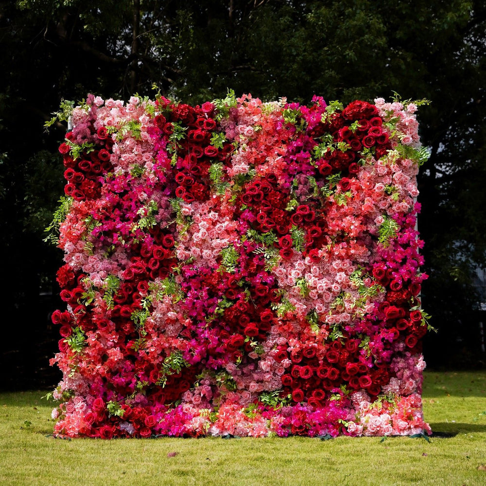Floral letter 'W' made of pink and red flowers on a grassy background