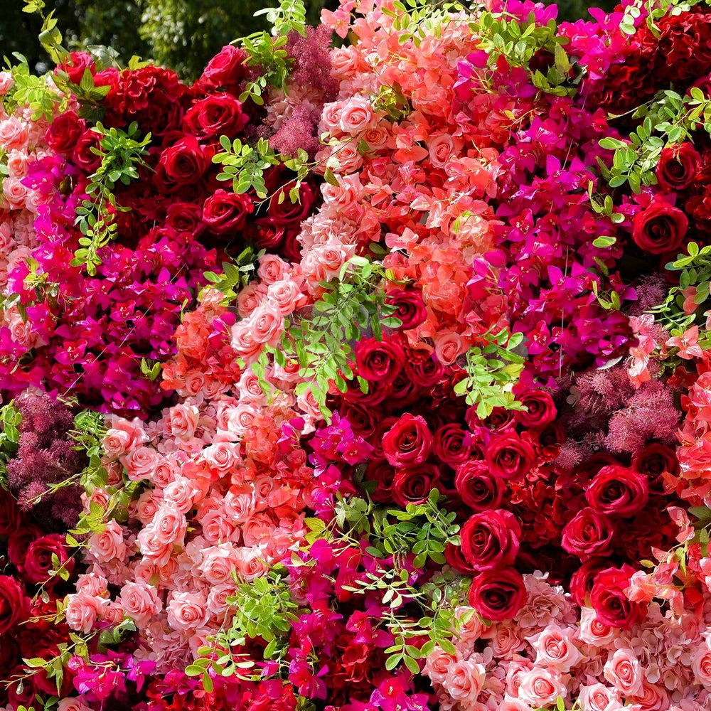 Wall of pink, red, and green artificial flowers