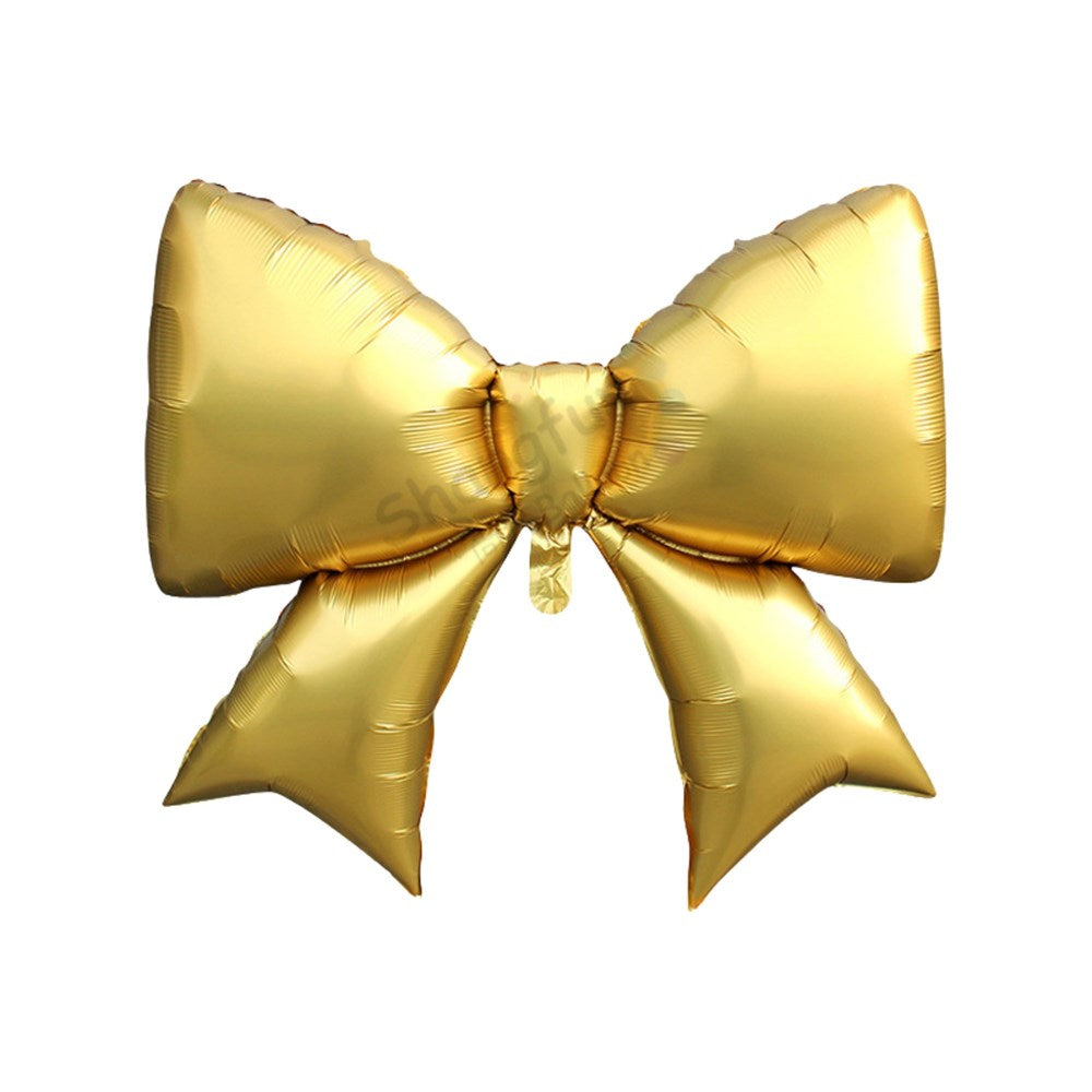 A metallic gold bow-shaped foil balloon isolated on a plain white background.