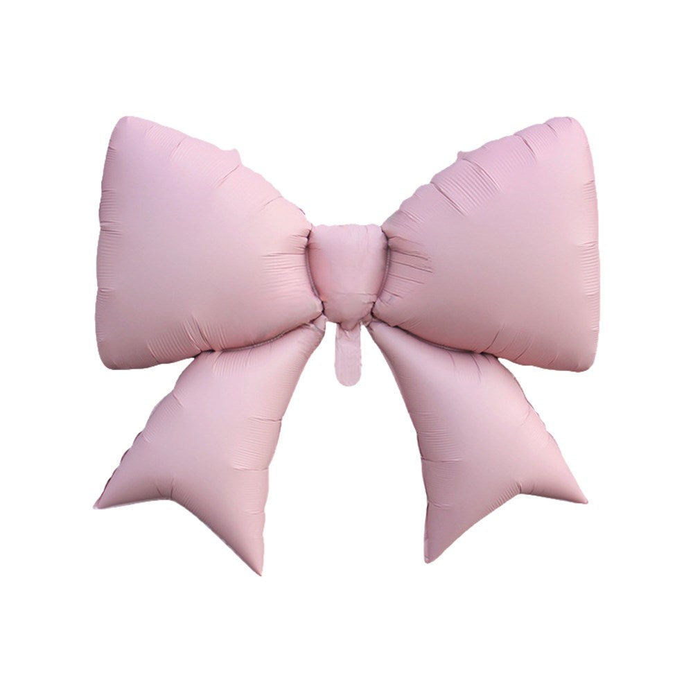 A large, inflatable pink bow-shaped balloon isolated on a solid white background.