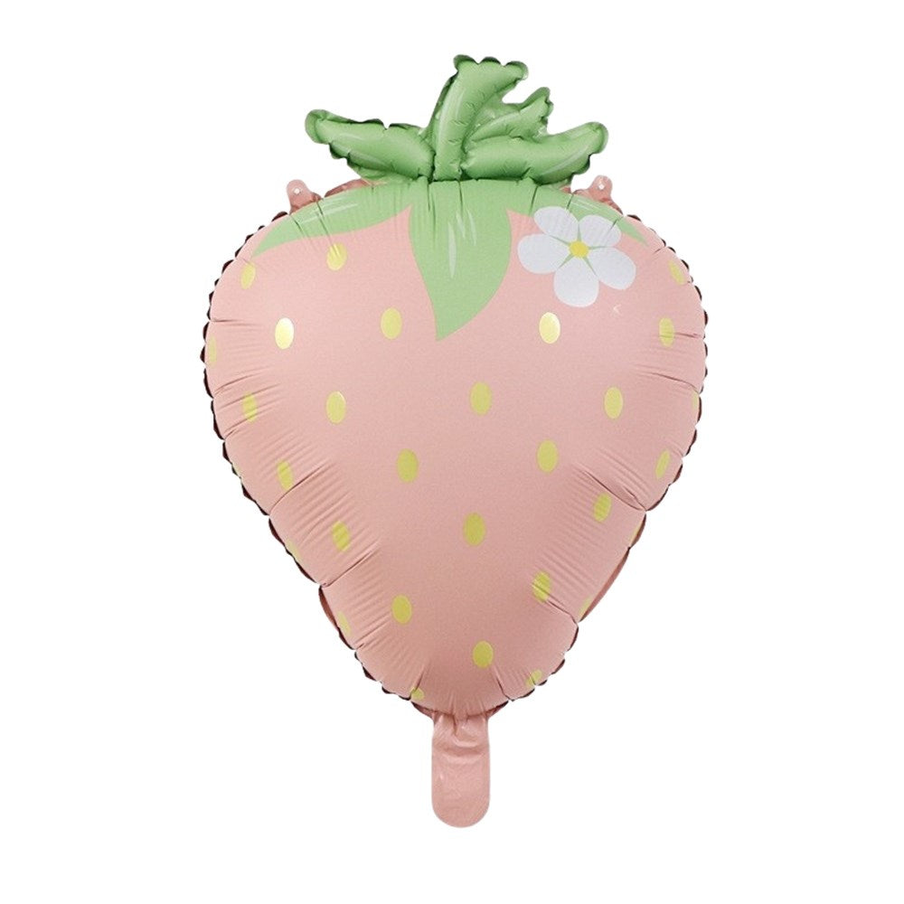 A strawberry-shaped foil balloon in light pink with green leaves, yellow-green seeds, and a small white flower, shown on a plain white background.