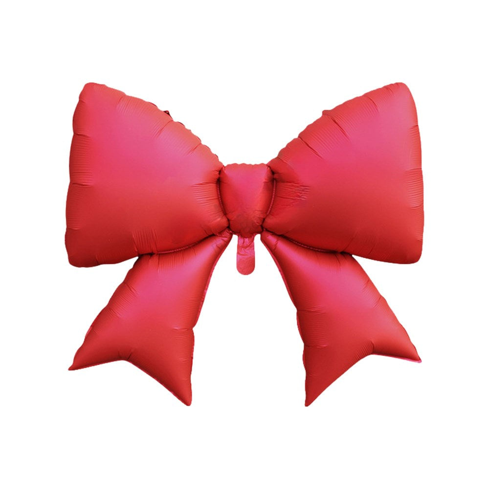 A large red foil balloon shaped like a bow with two long tails, isolated on a solid white background.