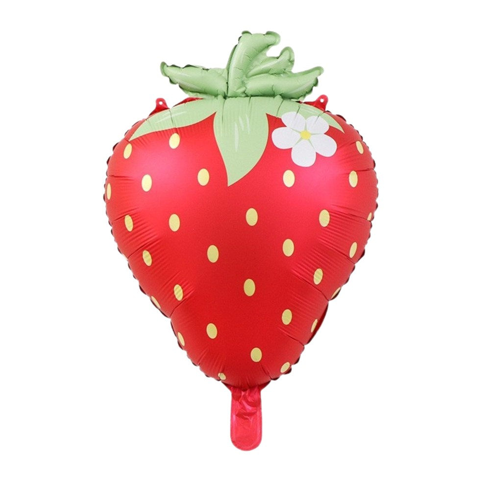 A strawberry-shaped foil balloon on a solid white background, featuring a glossy red body with yellow seeds, a green leafy top, and a small white flower detail.