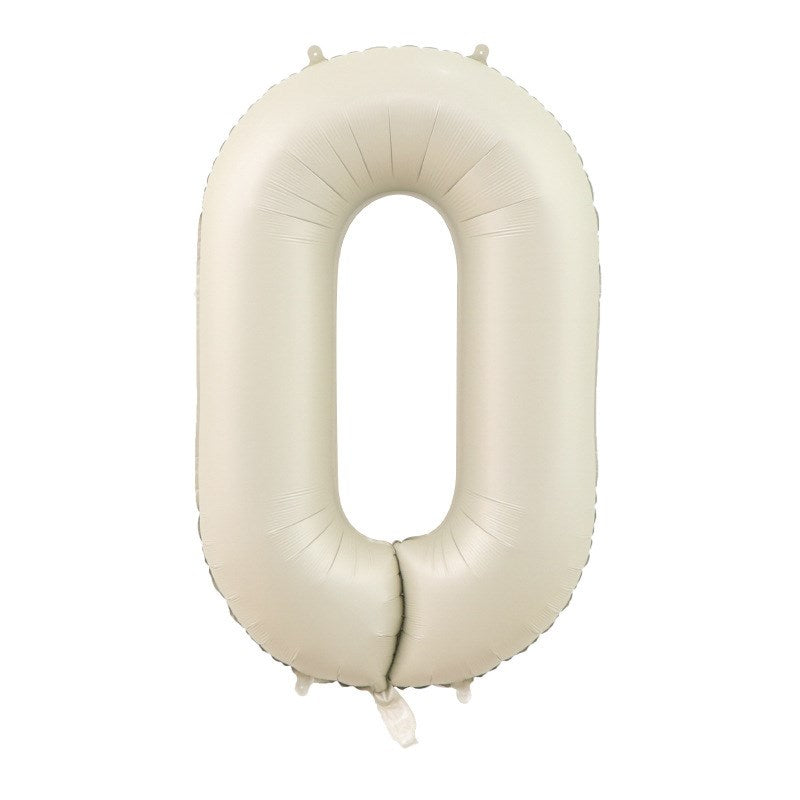 A cream-colored matte foil balloon in the shape of the number zero.