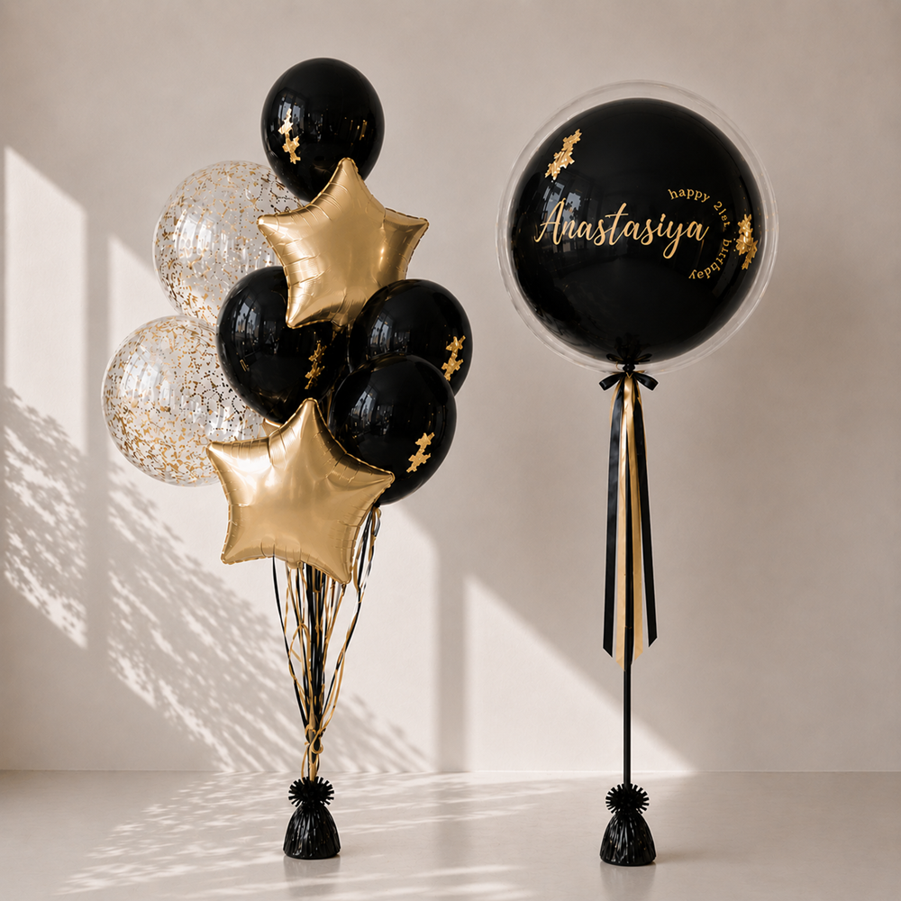 Decorative balloons with gold stars and black balloons on a neutral background