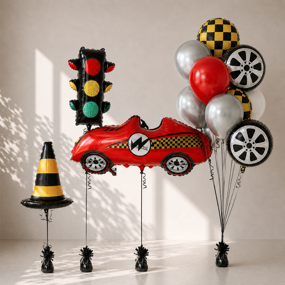 Collection of themed balloons including a car, traffic light, and traffic cone on a neutral background.