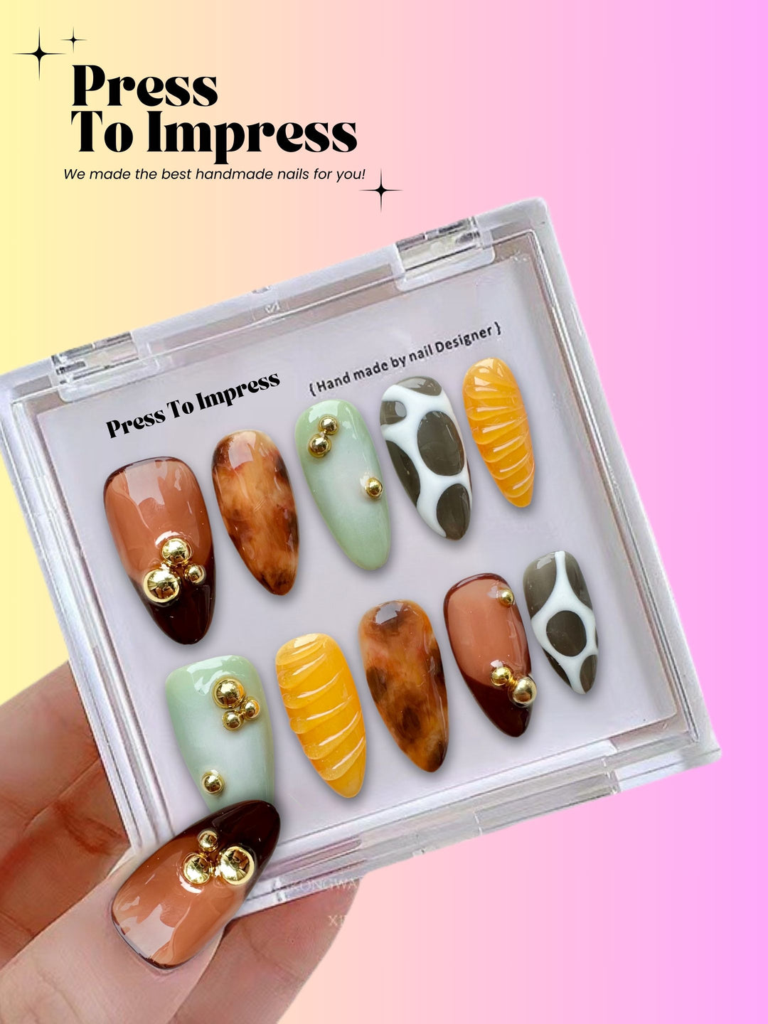 A hand holds a clear plastic case displaying 10 press-on nails with various patterns and colors, including brown, mint green, yellow, and white with gold accents. The background is a pink and yellow gradient with the text 'Press To Impress'.