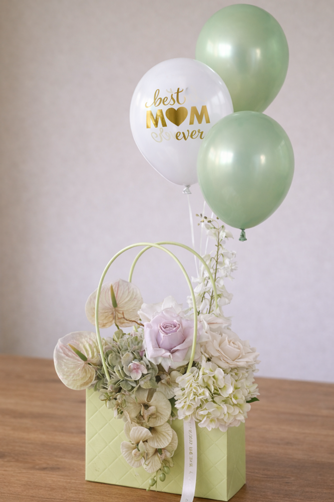 Mother’s Day flower arrangement with balloons and “Best Mom Ever” balloon.