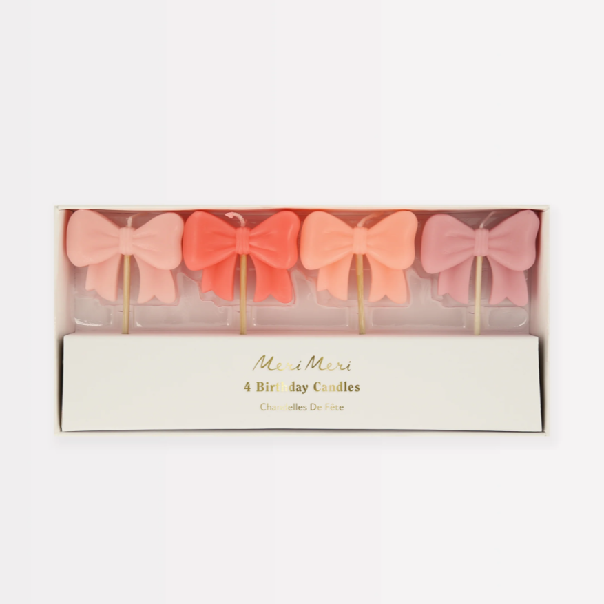 Set of four bow-shaped birthday candles in a decorative box with 'Me & My' branding.