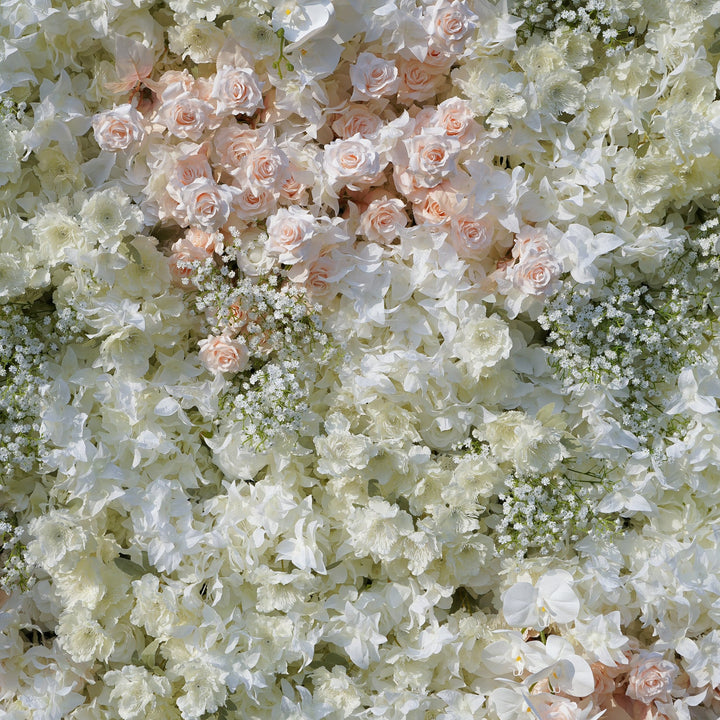 Wall of white and light pink flowers with greenery