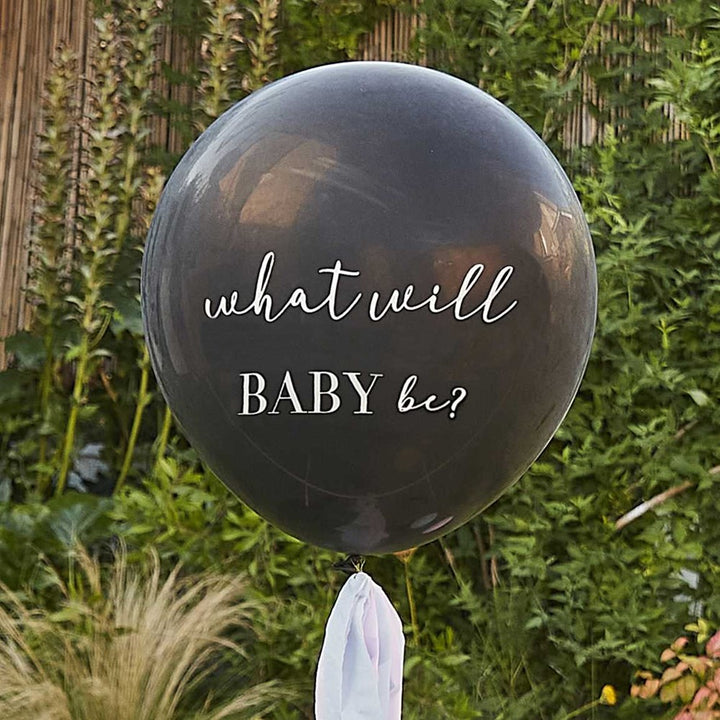 Gender reveal hoop backdrop with blue and pink balloons and black pop balloon.