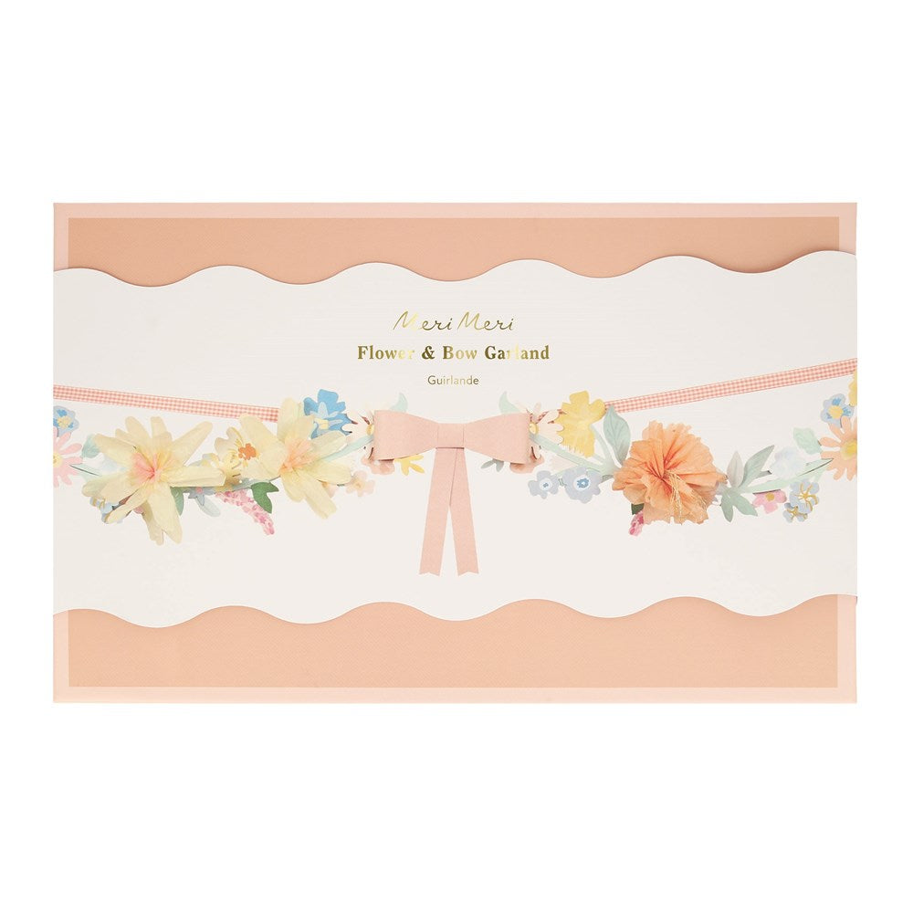 Floral and bow garland packaging with 'Merci Merci' branding on a white background