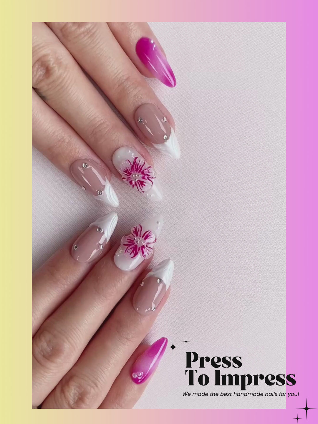 Video shows A hand holds a clear plastic case displaying press-on nails. The nails are glossy pink ombre, nude beige with white tips, and two white nails with pink floral designs.