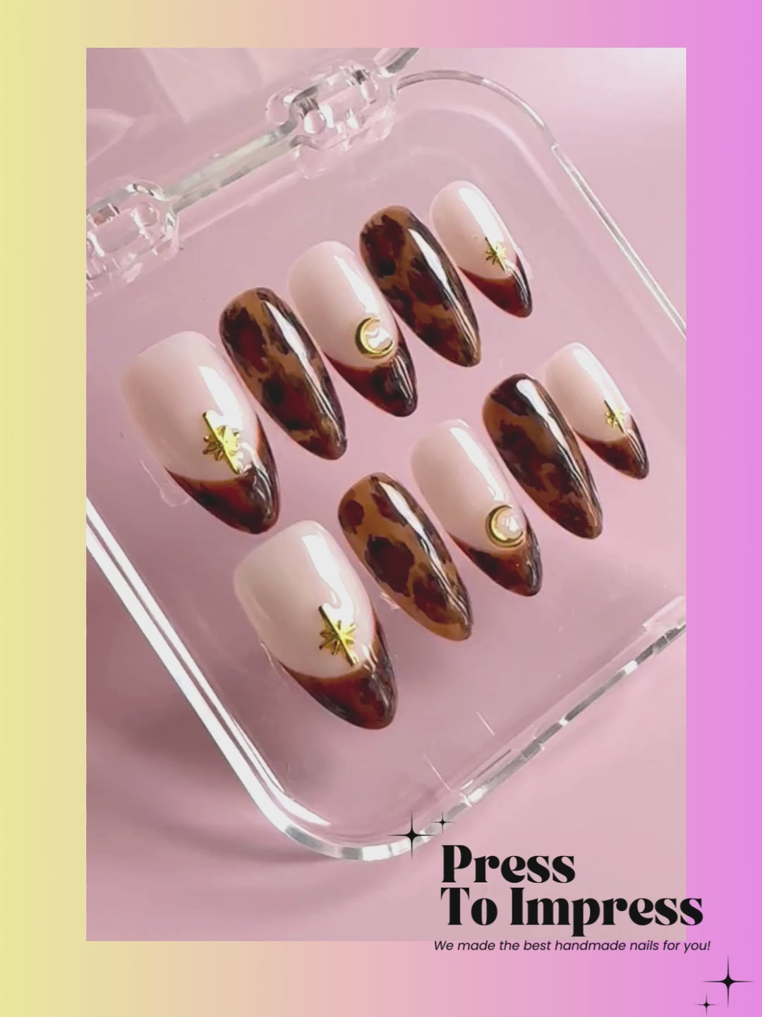 A Video shows A hand holds a clear plastic case containing press-on nails with a cream and brown leopard print design, gold crescent moon and star accents, and a gold leaf motif. The background is a soft pink-to-yellow gradient with the text 'Press To Impress' at the top.