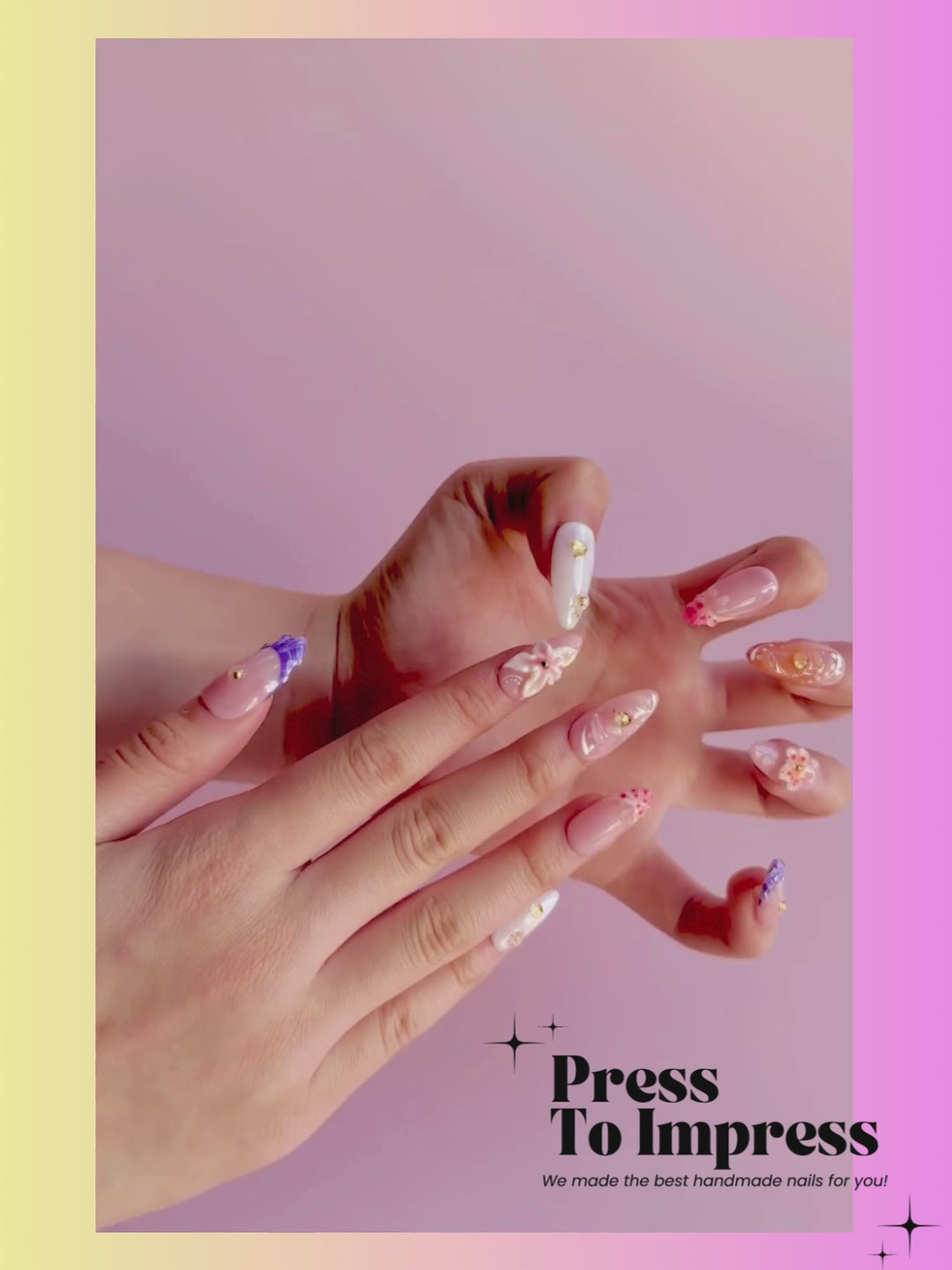 Video shows A hand holds a clear plastic case displaying ten decorative press-on nails. The nails feature pastel pink, peach, white, and purple designs with floral details, glitter, and rhinestones.