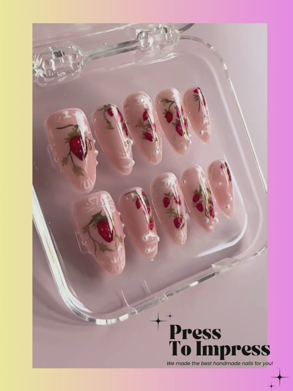A Video shows A hand holds a clear plastic case containing ten decorative press-on nails with a pale pink base, white floral patterns, and red strawberry motifs. The background is a soft pink-to-yellow gradient with the text 'Press To Impress' at the top.