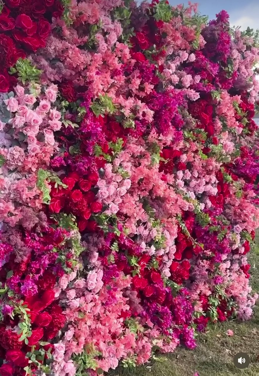 Bouquet of pink and red roses with green leaves against a blurred natural background