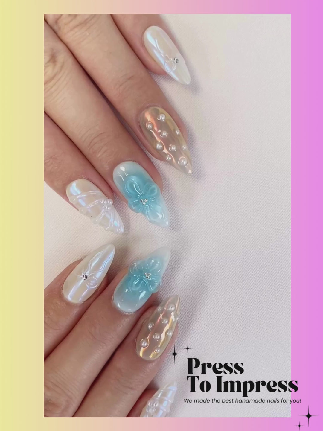 Video shows A hand holds a clear plastic case displaying ten decorative press-on nails with iridescent pearl-like dots and blue floral designs, set against a pink-to-yellow gradient background with 'Press To Impress' branding.