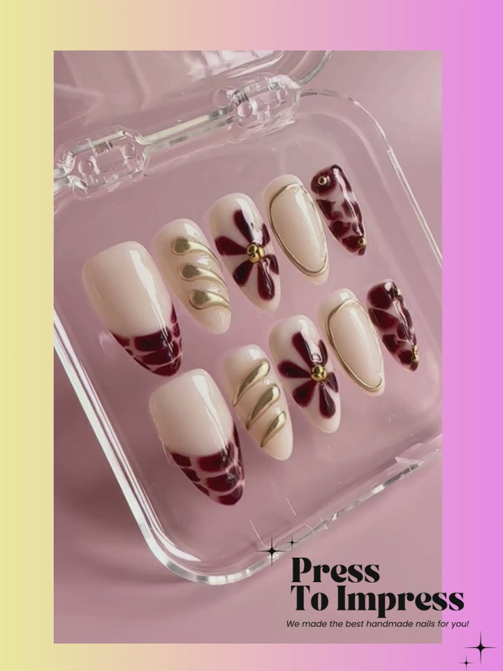 A Video shows A hand holds a clear plastic case displaying a set of press-on nails with cream bases and brown abstract patterns, against a pink-to-yellow gradient background with 'Press To Impress' branding.