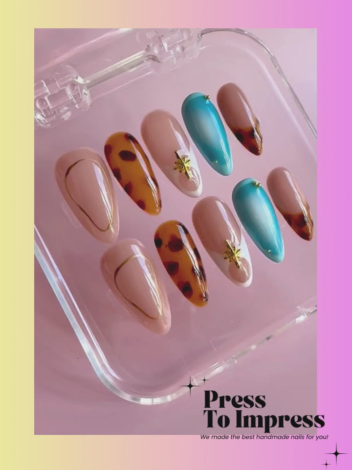 video A hand holds a clear plastic case displaying press-on nails with a variety of designs, including nude, brown, turquoise, and leopard print, against a pink and yellow gradient background with 'Press To Impress' branding.