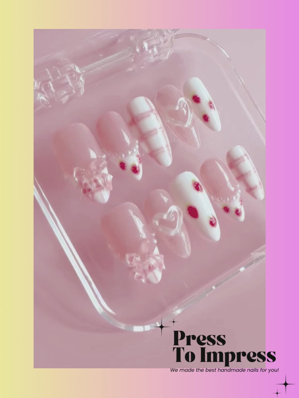 Video shows A hand holds a clear plastic case displaying decorative press-on nails. The nails feature pastel pink and white designs with red strawberry accents, white hearts, and plaid details.
