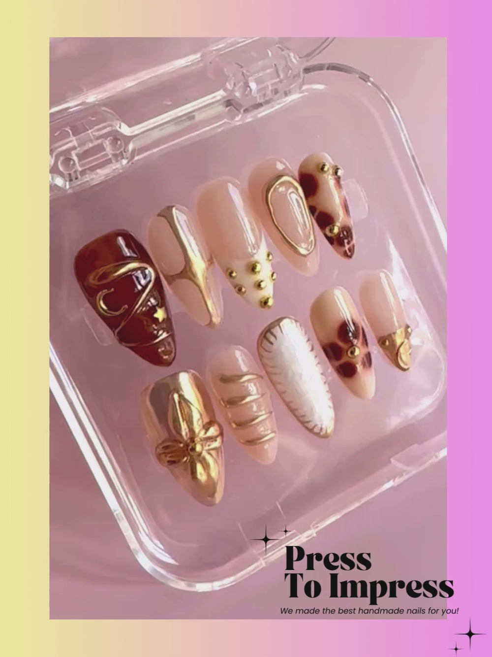 A video shows A hand holds a clear plastic case displaying ten decorative press-on nails. The nails feature nude beige, brown, gold glitter, and textured designs