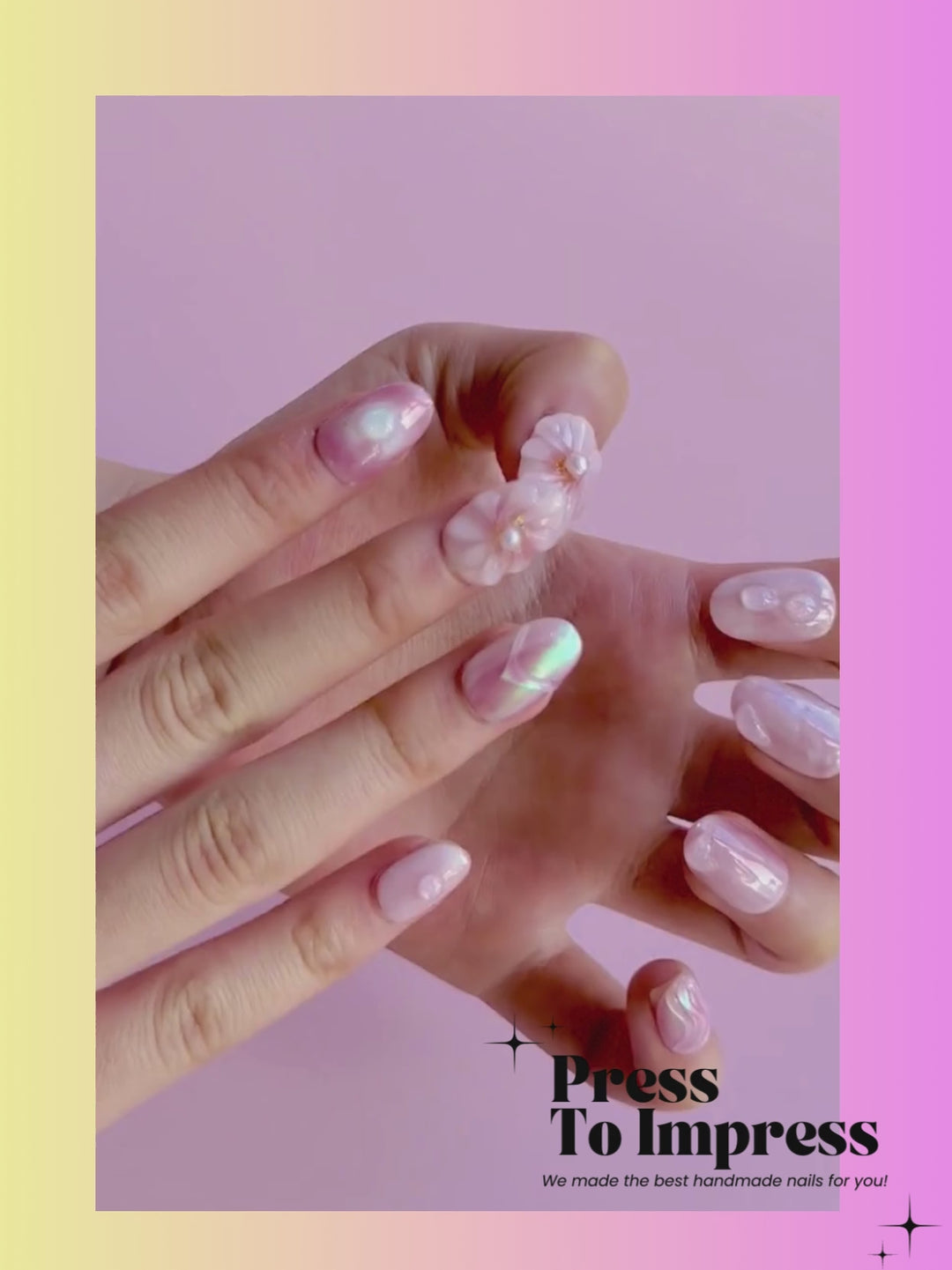 A video shows A hand holds a clear plastic case displaying decorative press-on nails. The nails feature pink and white marbled designs, floral motifs with pearl centers, and swirl patterns.