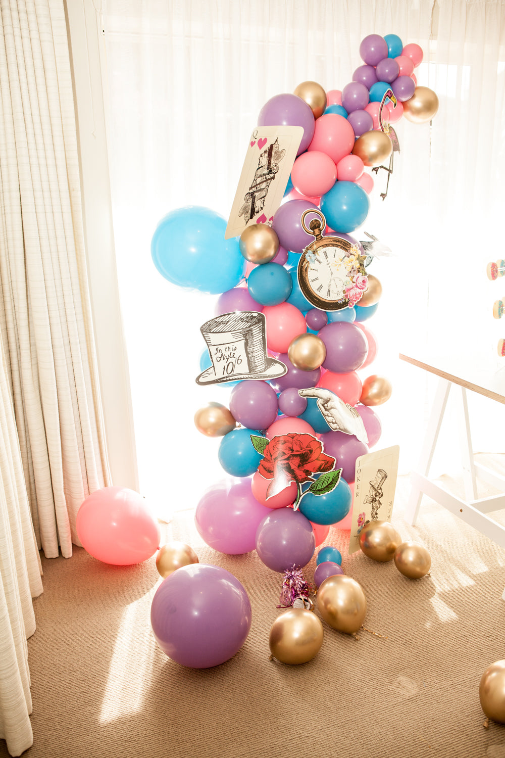 Alice in Wonderland Prop on balloon garland with Pink, blue and Purple color.
