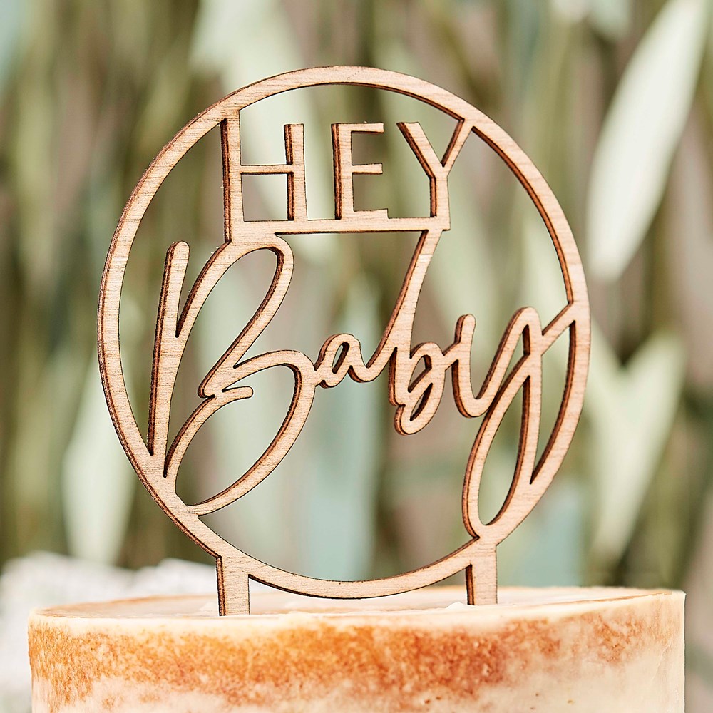 Ginger Ray Botanical Hey Baby Wooden Cake Topper on a cake