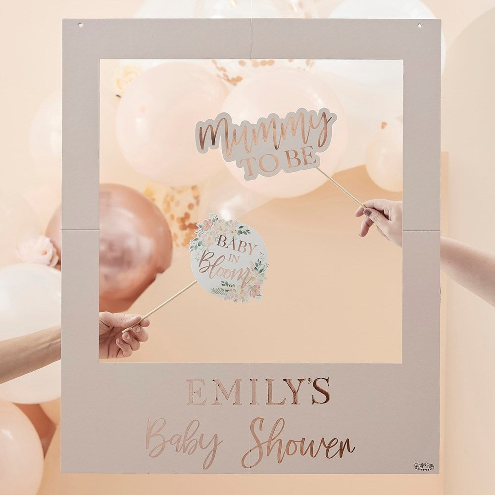 Baby in Bloom Baby Shower Customisable Floral Photo booth Frame in font of a balloon garland