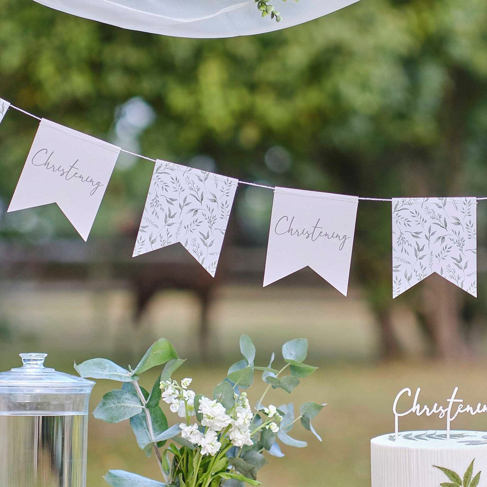 Ginger Ray Christening White & Green Botanical Bunting Over dessert table in garden with details